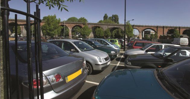 Busy car park, day.