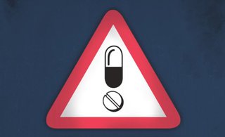 Don't-drug-drive warning sign, pill images inside red triangle.