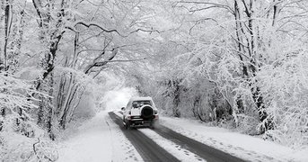 4 x 4 x vehicle driving thourgh rural snowy conditions