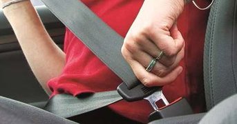 Girl handling seatbelt clip into position.